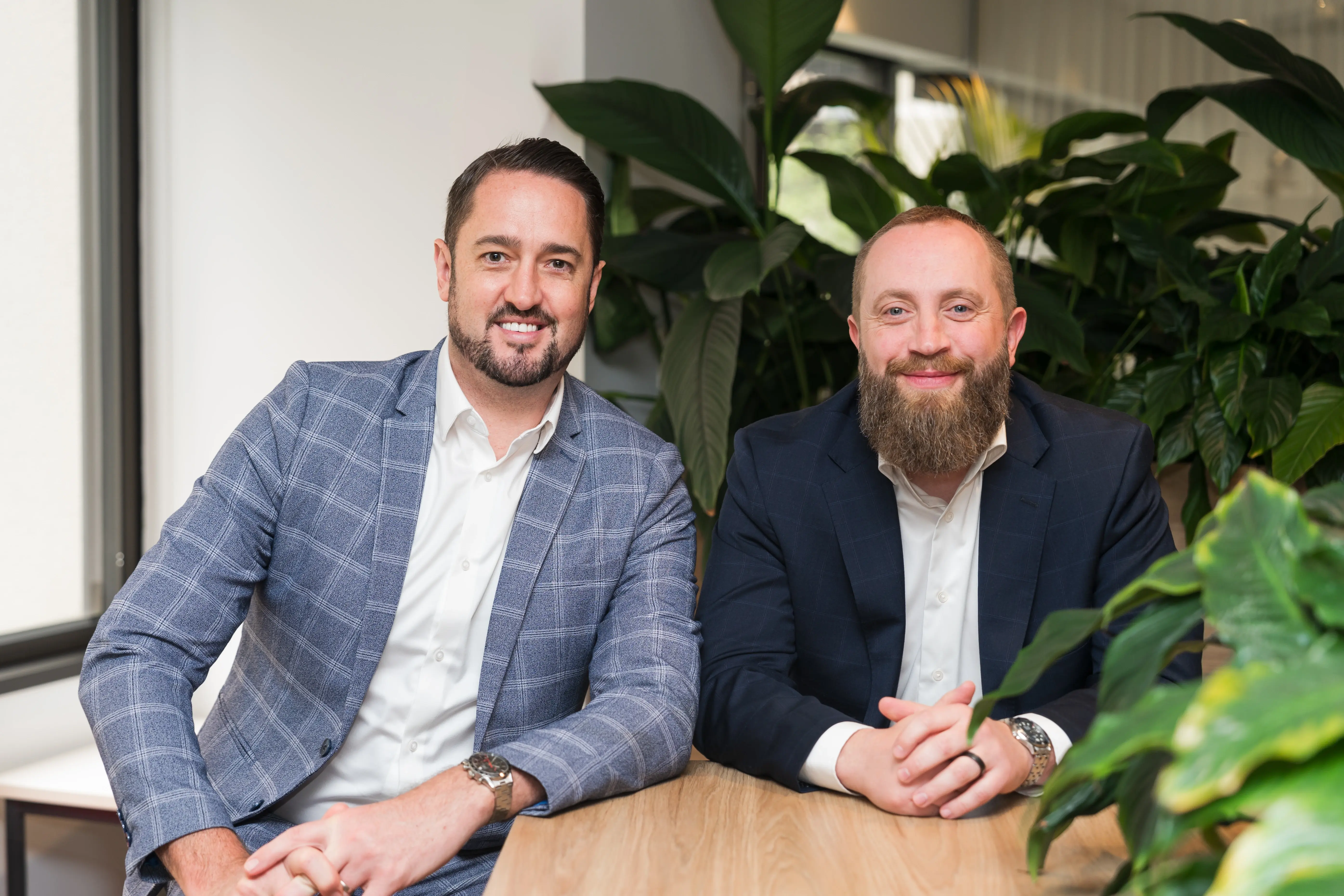 Mathew and Andrew smiling at desk